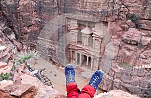 Girl hiking boots on Al-Khazneh background. Al-Khazneh (The Treasury) is beautiful temple in the ancient Nabatean city of Petra