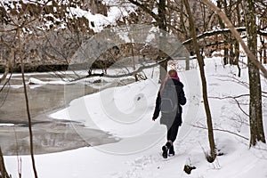 Girl hiking in cold, white winter.