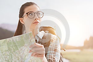 Girl hiking and holding a map