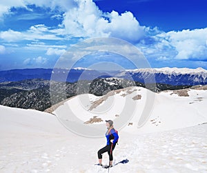 Girl hiking .Snow on the top of the Tahtali mountain