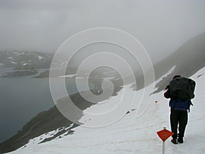 Girl hiking in snowfield and fog