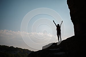 Girl on hill against sun