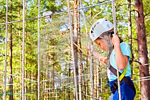 Girl on hinged trail in extreme rope Park