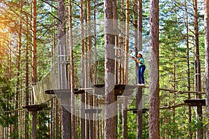 Girl on hinged trail in extreme rope Park