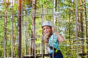 Girl on hinged trail in extreme rope Park