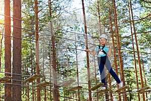 Girl on hinged trail in extreme rope Park