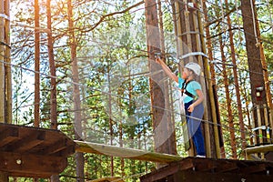 Girl on hinged trail in extreme rope Park