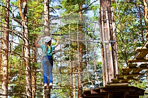 Girl on hinged trail in extreme rope Park