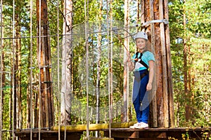 Girl on hinged trail in extreme rope Park