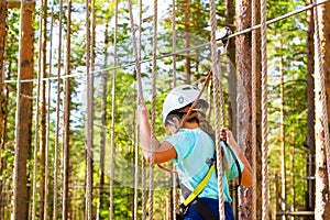 Girl on hinged trail in extreme rope Park