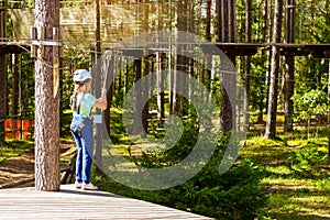 Girl on hinged trail in extreme rope Park