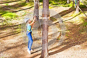 Girl on hinged trail in extreme rope Park