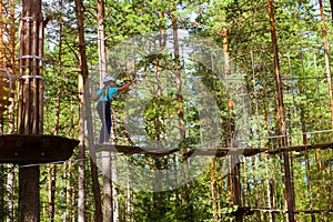 Girl on hinged trail in extreme rope Park