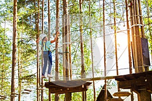 Girl on hinged trail in extreme rope Park