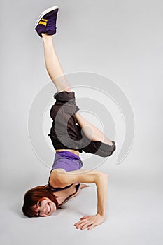 Girl in hip-hop clothes making freeze photo