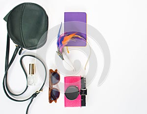 Girl, hippie stuff background. Green cross bag, retro brown sunglasses, pink retro camera, lilac notebook, colorful headband. Flat