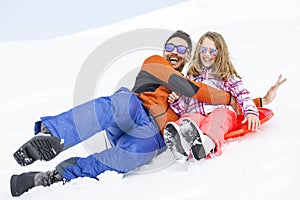 Girl and his father sledding very fast