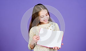 Girl hold book violet background. Kid show book notepad. Book concept. Childhood literature. Development and education