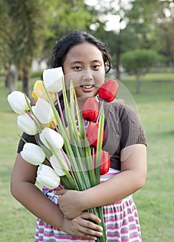 Girl hold bouquet of tulip flowers standing in ther garden