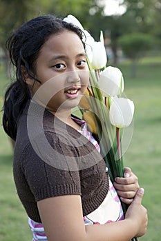 Girl hold bouquet of tulip flowers standing in ther garden