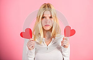 Girl hold heart love symbol over pink background. Valentines day concept. How to feel less lonely on valentines day