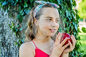 Girl hold red ripe natural organic apple, healthy nutrition concept