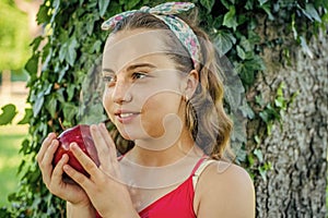 Girl hold red ripe natural organic apple, healthy nutrition concept