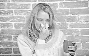 Girl hold tea mug and tissue. Runny nose and other symptoms of cold. Drinking plenty fluid important for ensuring speedy