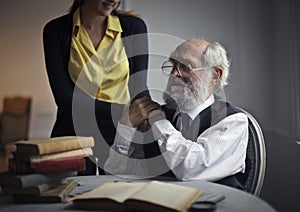 A girl holding aged man`s hands