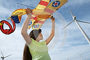 Girl Holding Airplane Kite At Wind Farm