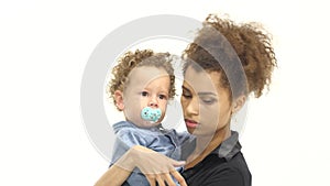 Girl is holding the baby, he has a nipple, he was crying. White background