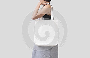 Girl is holding bag canvas fabric for mockup blank template