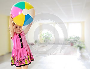Girl holding ball over head