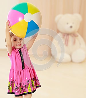 Girl holding ball over head