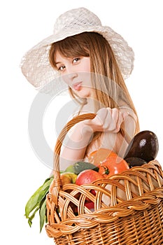 Girl holding a basket of fresh vegetables.