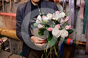 Girl holding a beautiful bouquet of white peony roses and pink tulips