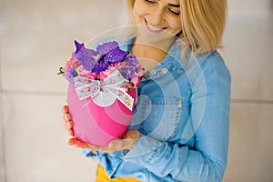 Girl holding beautiful pink bouquet of mixed flowers in vase