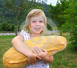 Girl holding big bread humor size hungry child