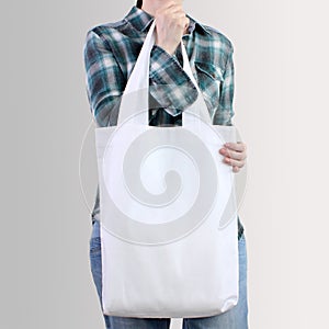 Girl is holding blank cotton tote bag, design mockup.