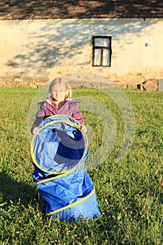 Girl holding blue kids tunnel