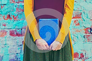 Girl holding book in hands