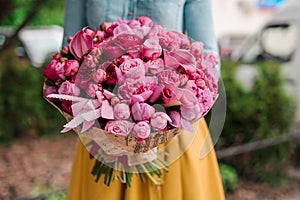 Girl holding a bouquet of pink flowers