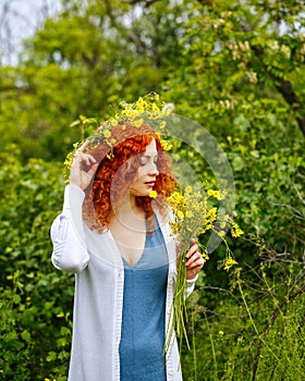 Girl holding a bouquet of wild flowers.