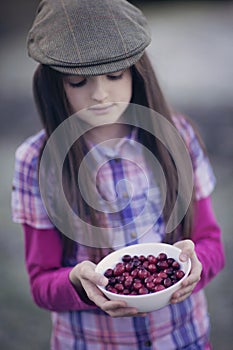 Girl holding bowl of cranberries