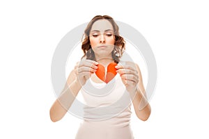 Girl holding broken paper red valentine heart