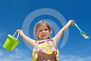 Girl holding bucket and spade