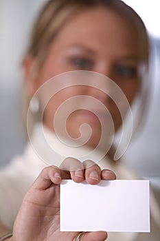 Girl holding business card focus