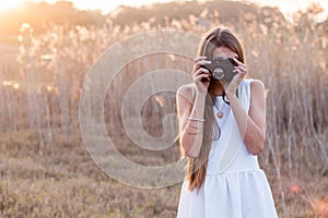 Girl holding a camera taking pictures