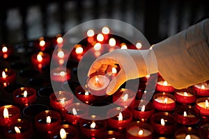 A girl is holding candle and praying near altar in church.