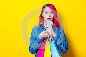 Girl holding a colored shopping bags and money